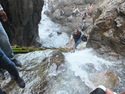 Aabhash climbing bamboo lader over rapids