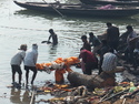 Bringing a body to the river and panning for gold among the ashes