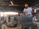 Guy sitting on roti machine