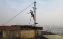 Hanging off the to of an abandon skyscraper