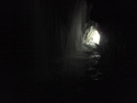 Lea in the distance of waterfall cave