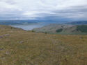 Looking down on white lake from surrounding peak
