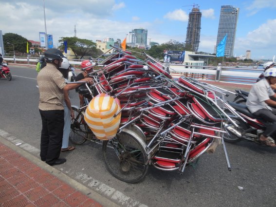 Lots of folding chairs on a tricycle