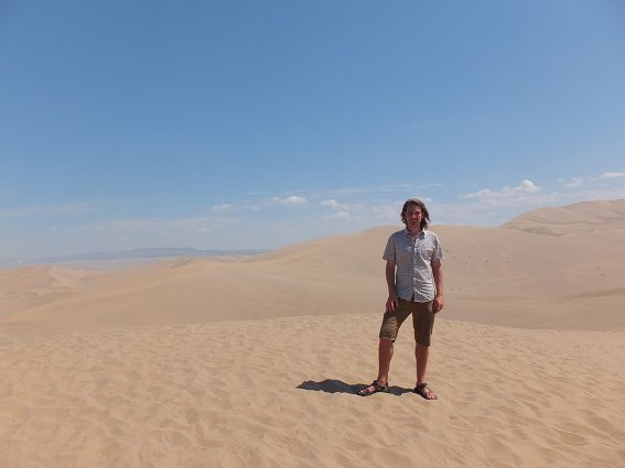 Me on a giant walled-off sand dune by Dunhuang