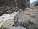 Me sitting on rock at tiger leaping gorge