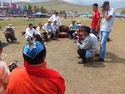 Men shooting bricks at naadam