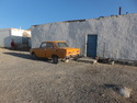 Orange car missing a tire