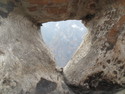 Tiger leaping gorge through a hole in a piece of wood