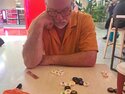Tony thinking through a game of Hive on our Doha layover
