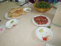 Everything shown is commonly served with food in Vietnam: A bowl of herbs, thin rice cakes, chili + salt + lime and peanuts. You make a very thick sauce to dip things in by squeezing the lime into the salt.